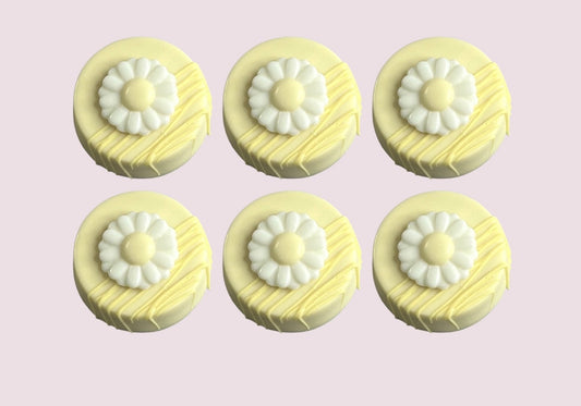 Set of six pastel yellow chocolate-covered Oreos with daisy toppers and decorative drizzle perfect for spring events and dessert platters. 